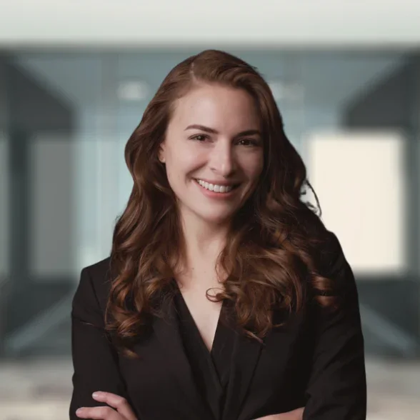 Tara Pedroncelli, a woman in professional attire, smiling in a bright office setting. Director of Human Resources at Postman Law.
