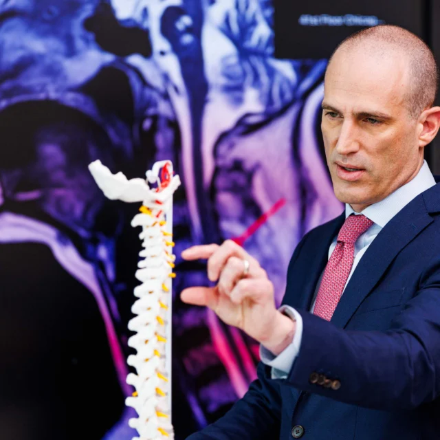 A lawyer examining a skeleton model.