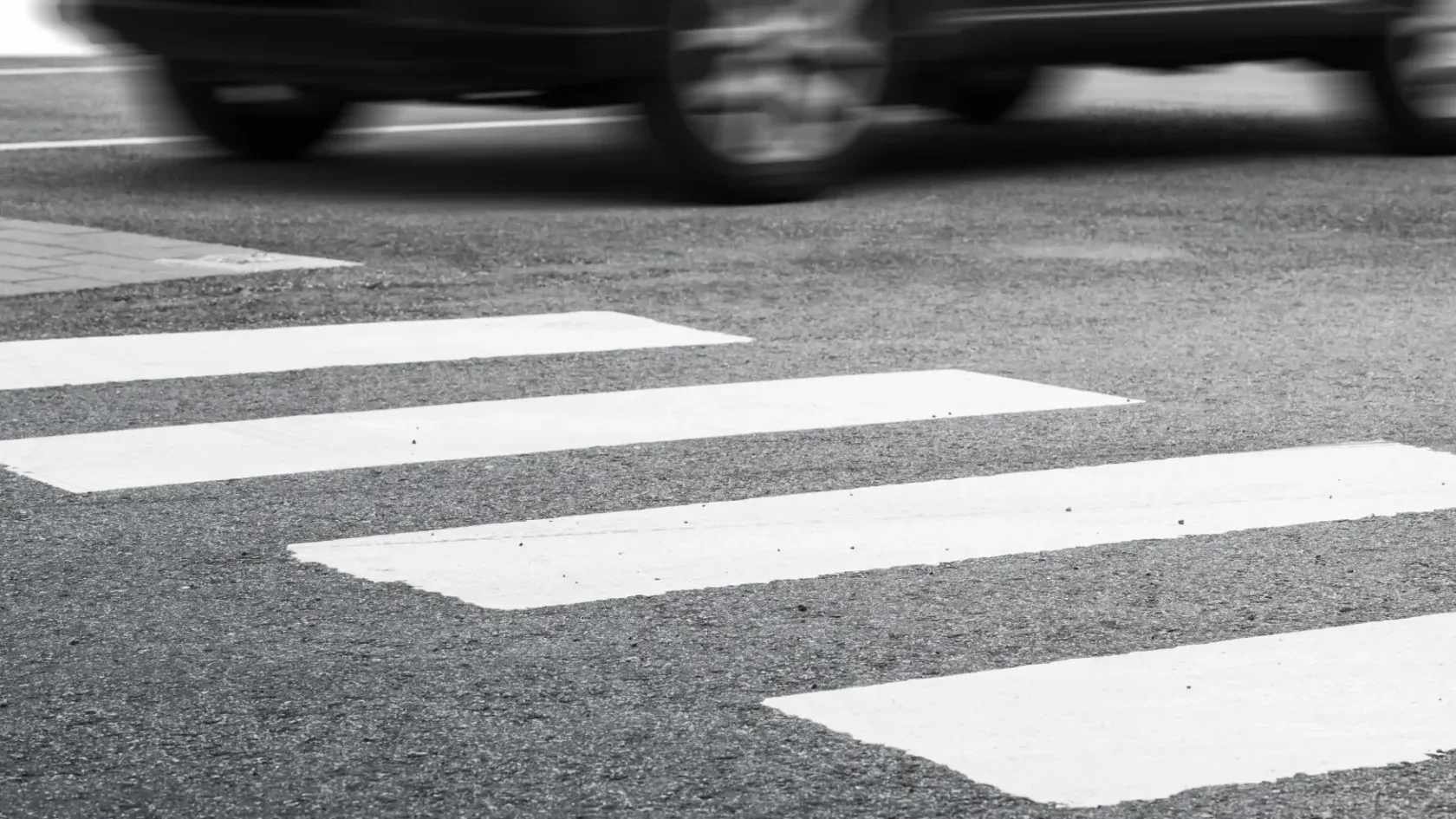 A crosswalk in black and white.