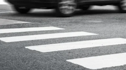 A crosswalk in black and white.